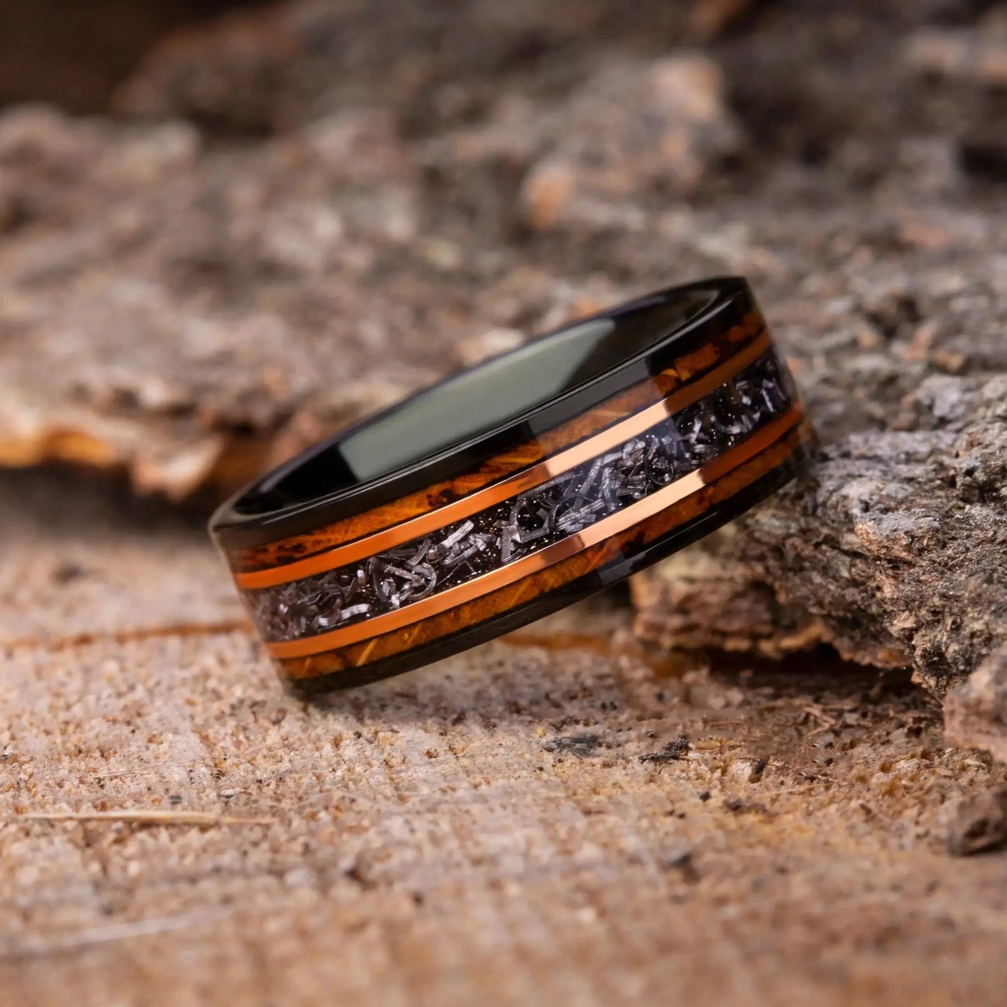 Wooden ring with black stone on a rustic wooden surface