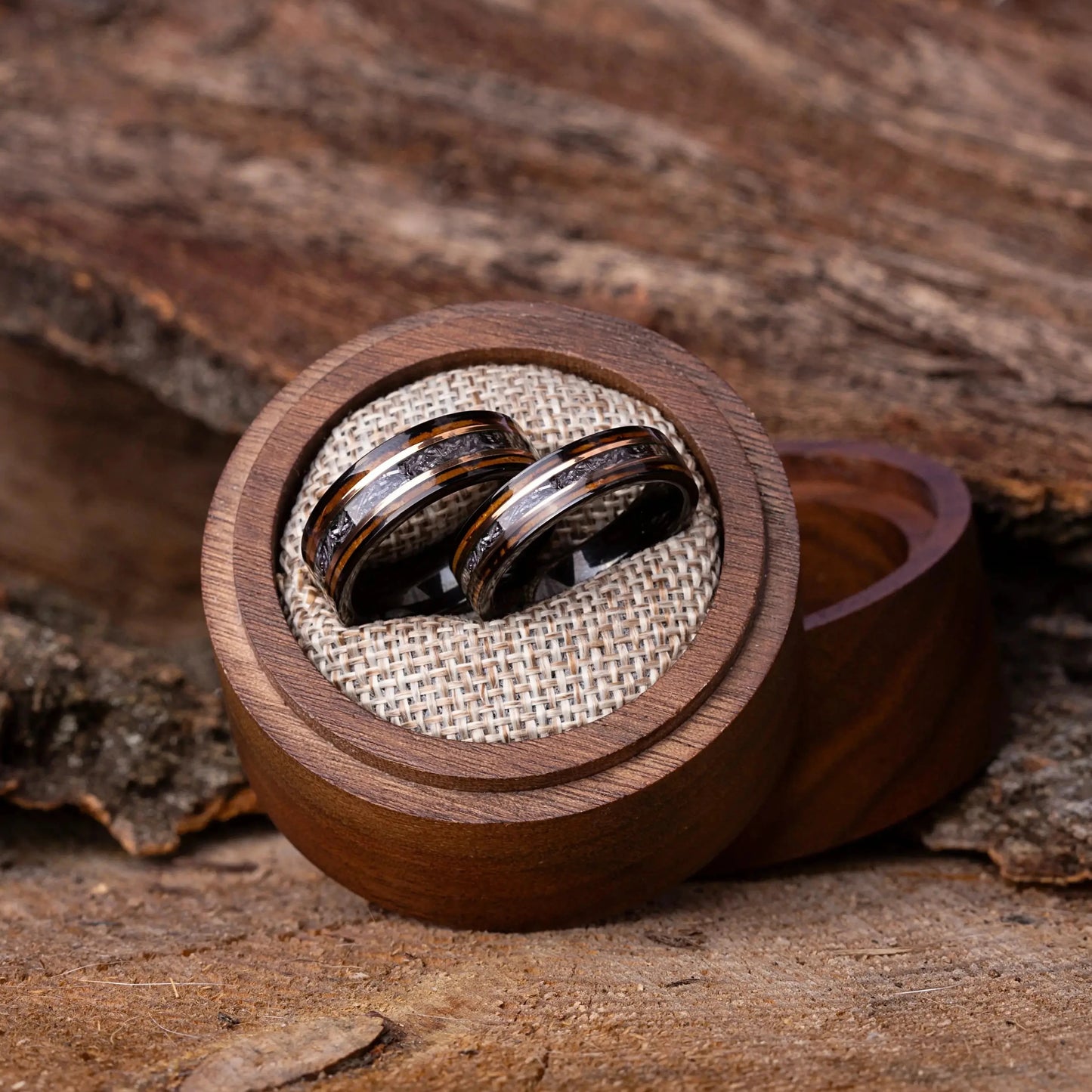 Wooden ring box with two rings on a wooden surface