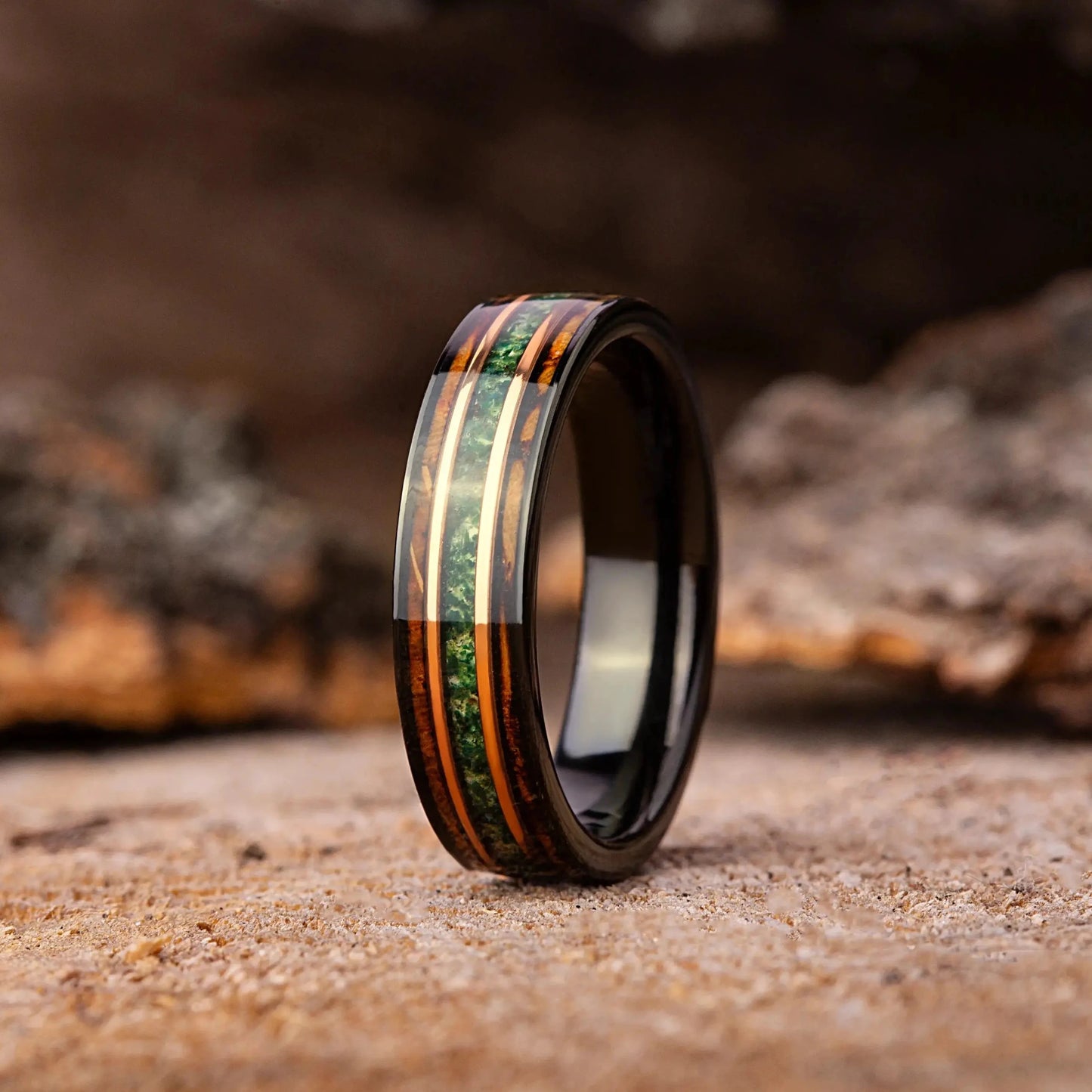 Wooden ring with colorful inlay on a rustic wooden background