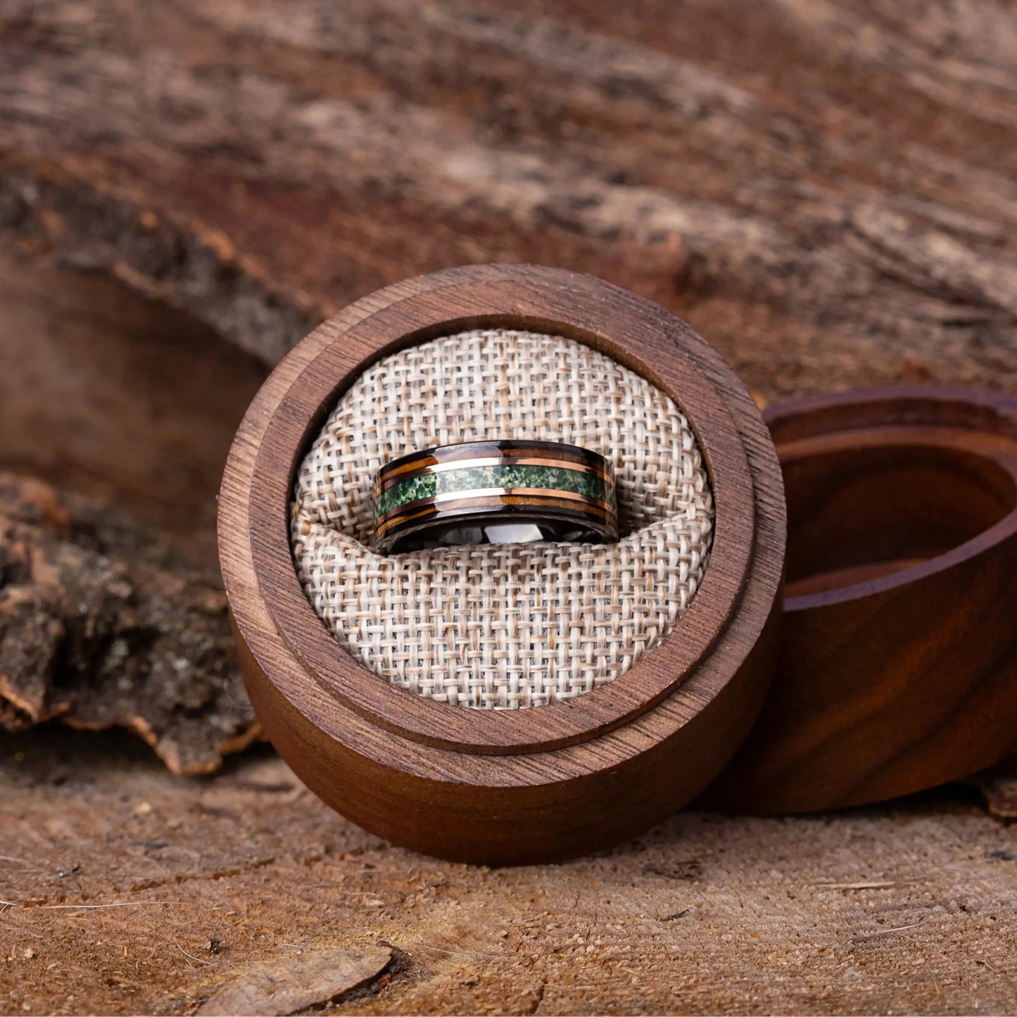 Wooden ring box with two rings on a wooden surface