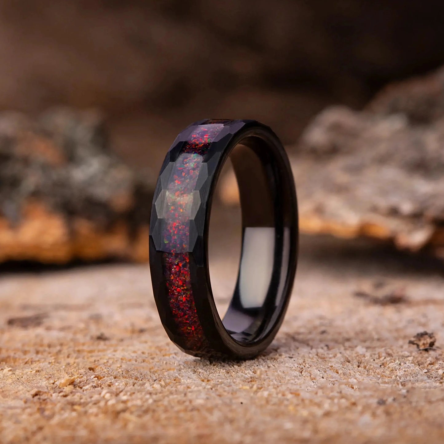 Wooden ring with red accents on a rustic wooden surface