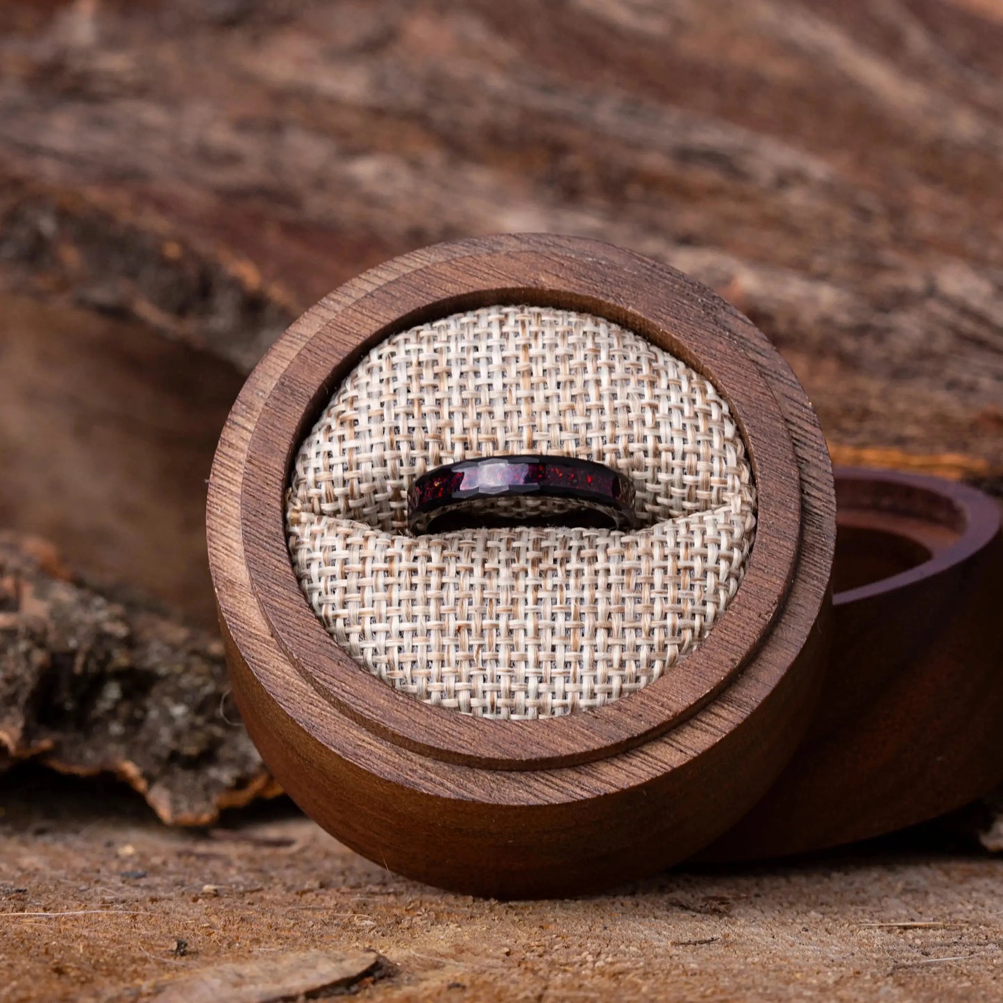 Wooden ring box with a ring on a rustic wooden surface
