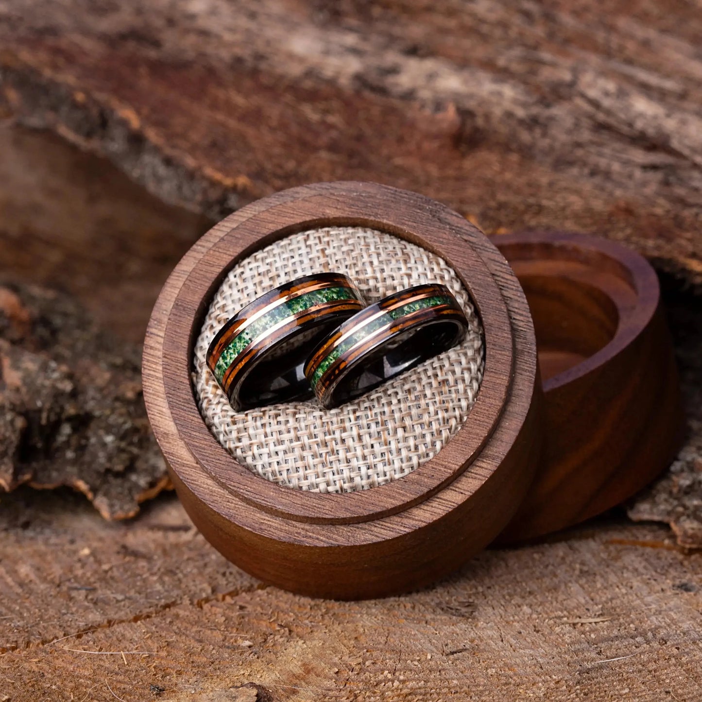 Wooden ring box with two rings on a wooden surface