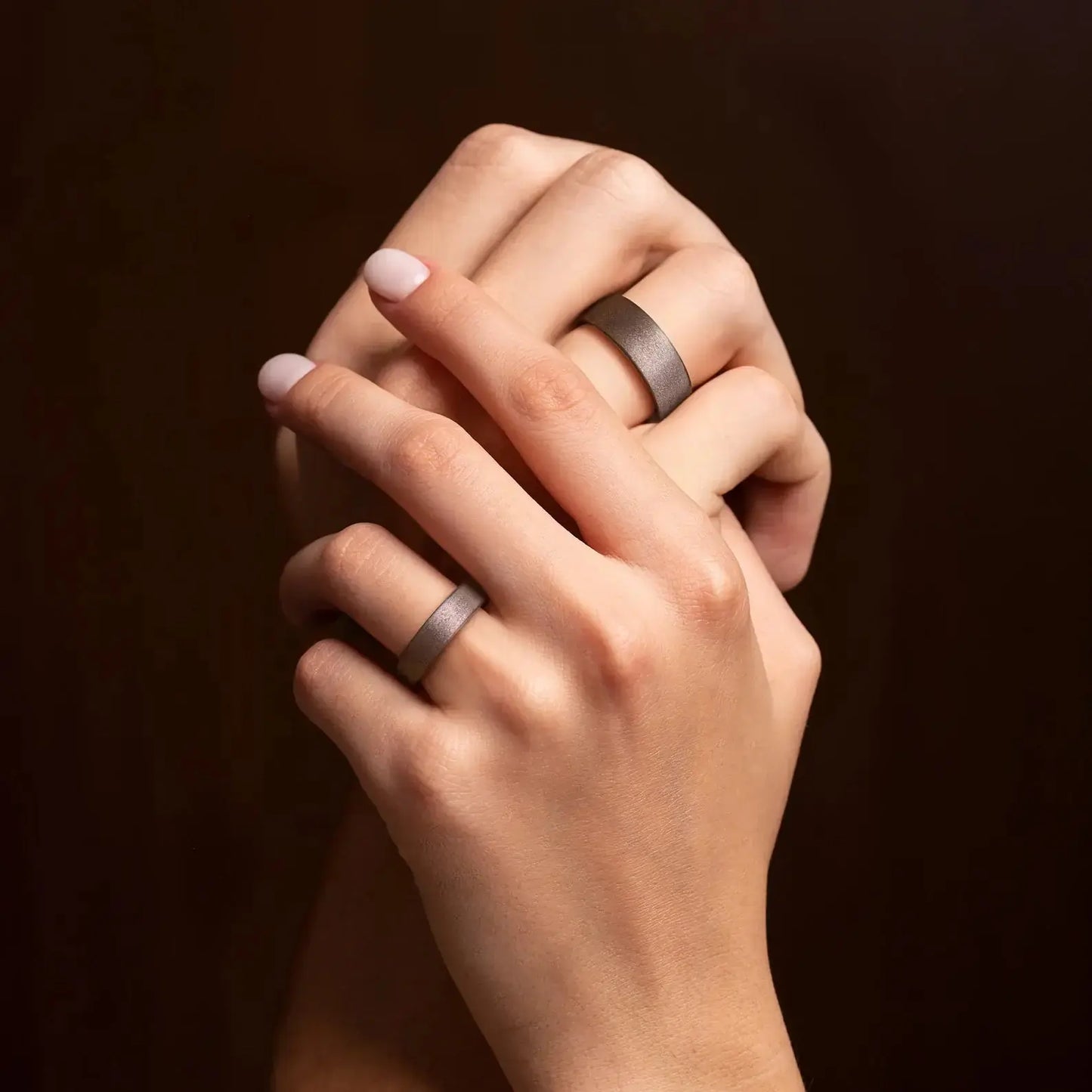 Sakura Wood couple wedding ring set on a man's and woman's hands