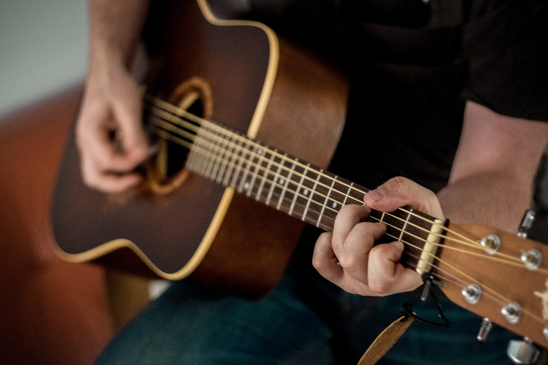 Man is playing on a guitar