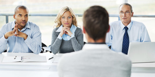 Man sitting in front of three people