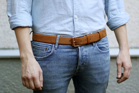 Man is wearing jeans with a brown belt