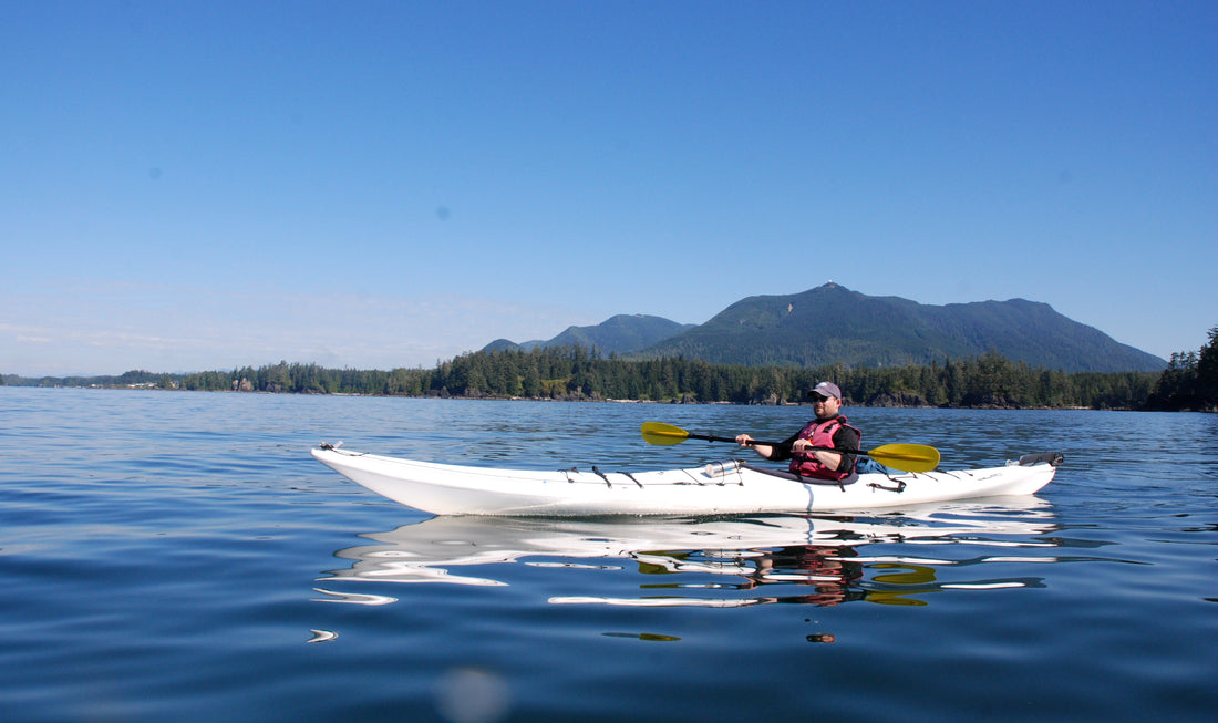 Man is swimming on a kayak