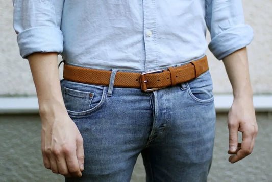 Man is wearing jeans with a brown belt