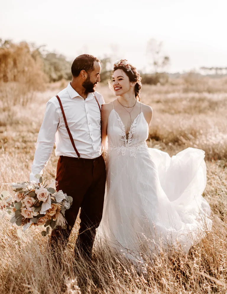 Bride and groom are staying on a grass