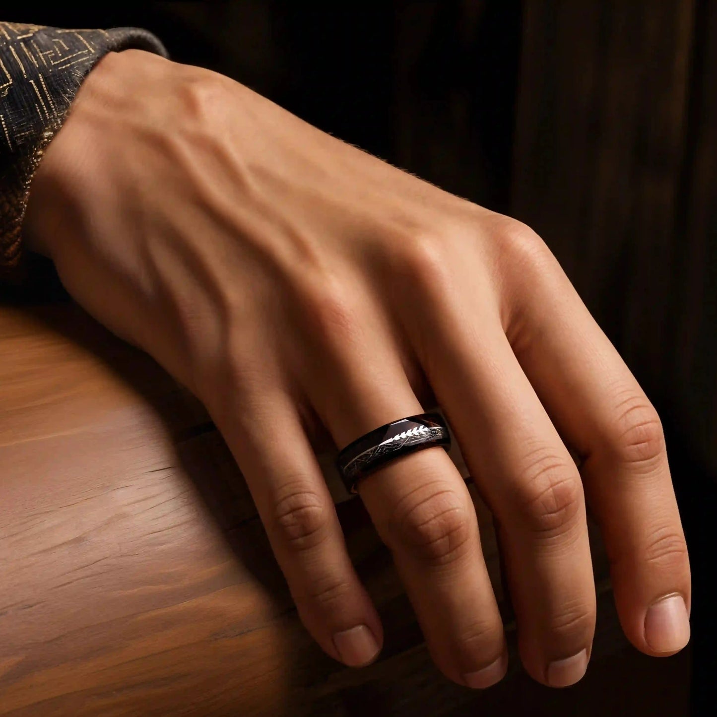 Black tungsten ring with meteorite, rosewood and arrow sign. the ring is placed on a man's hand