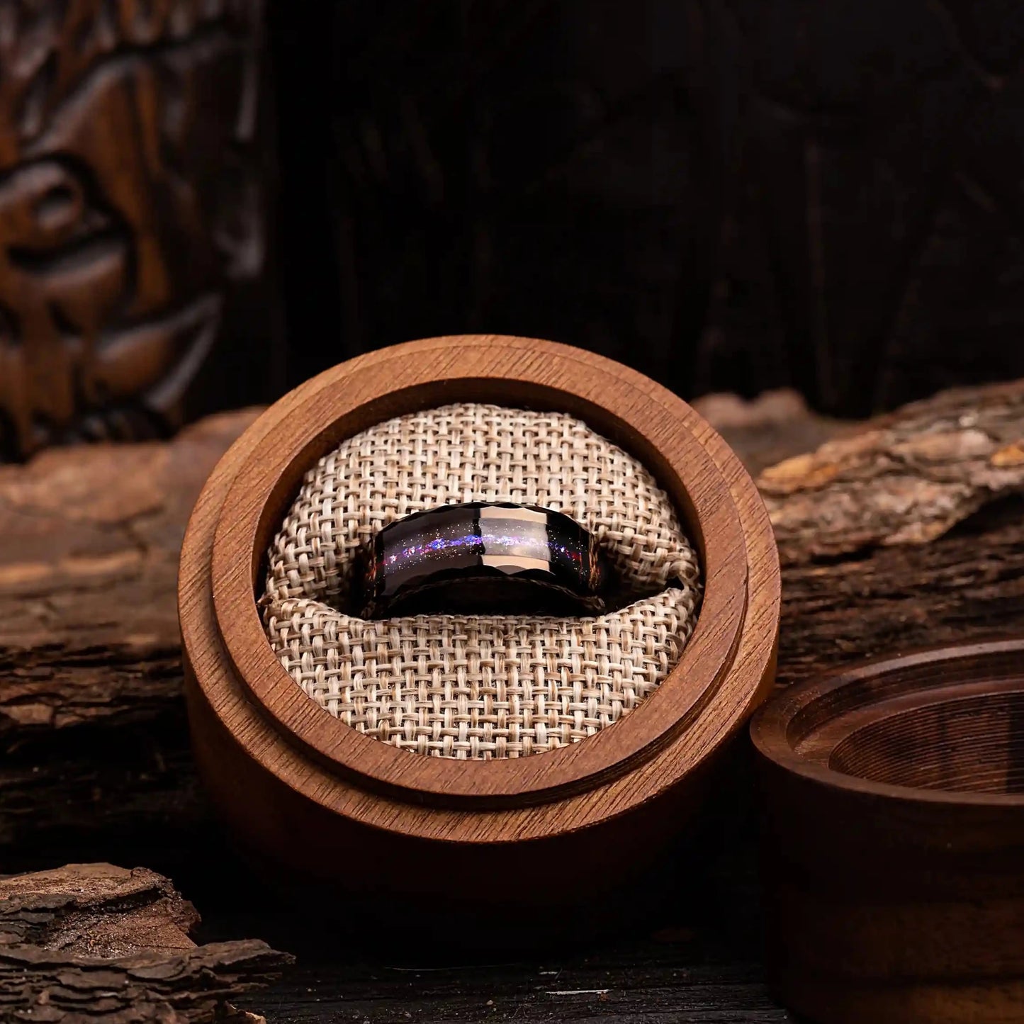 8mm hammered tungsten ring with opal and meteorite. The ring is placed inside a round wooden box