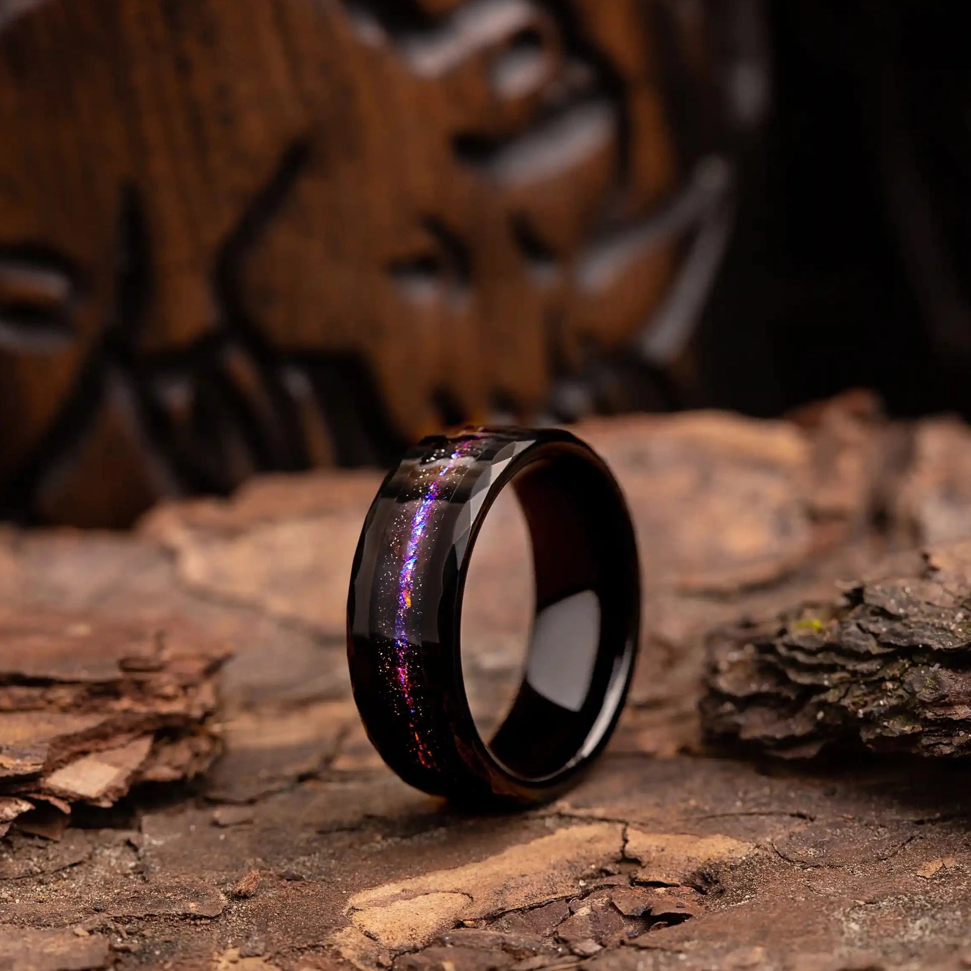 8mm hammered tungsten ring with opal and meteorite. The ring is placed on a wood