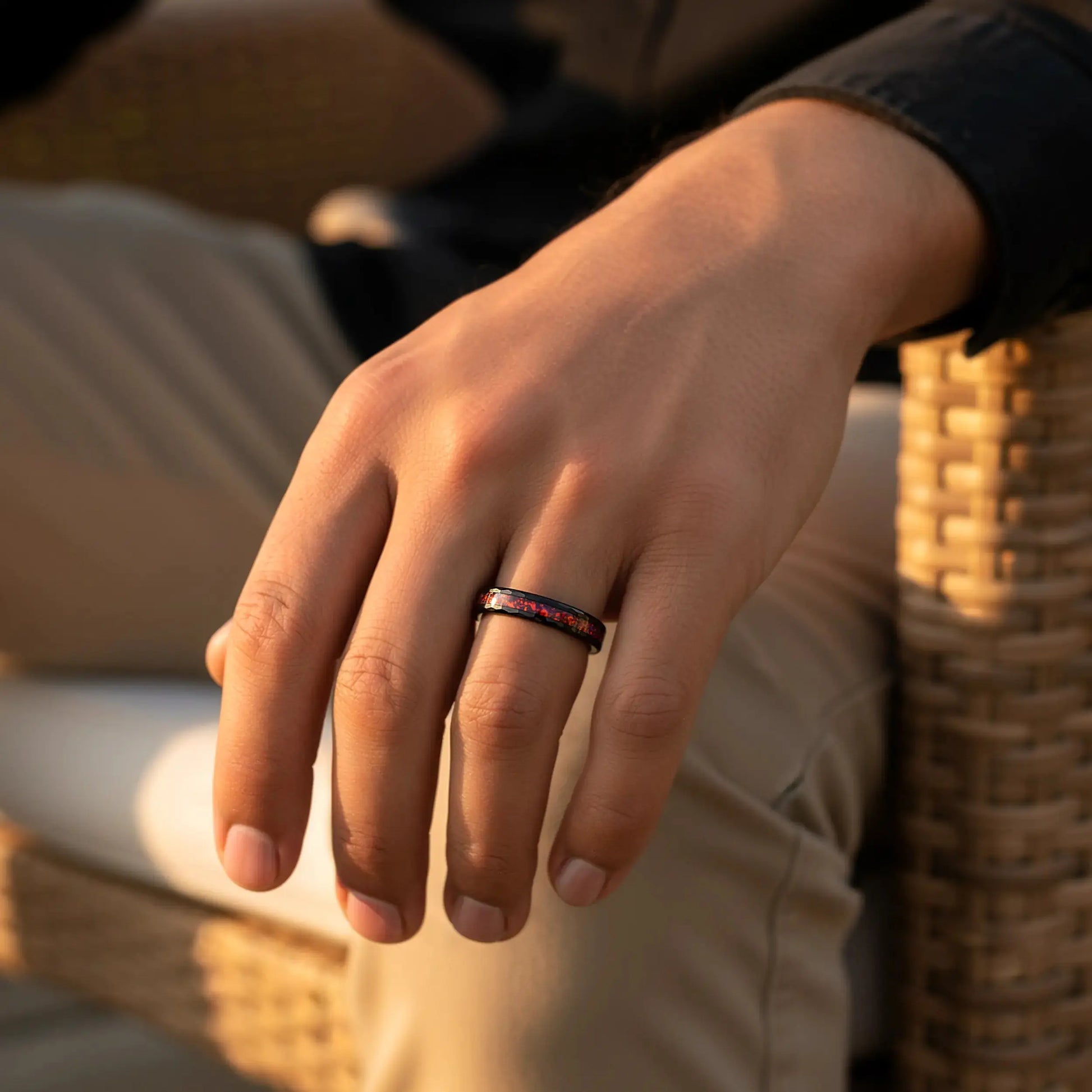 Close-up of a hand wearing a ring with a blurred background