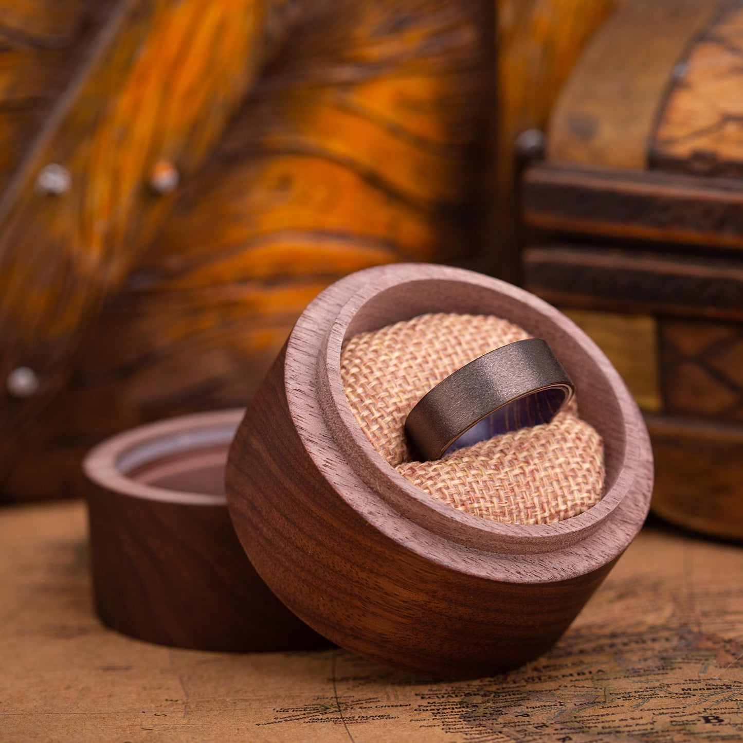 8mm Handcrafted ring made of Sakura wood and Tungsten. The ring is placed inside a round wooden box