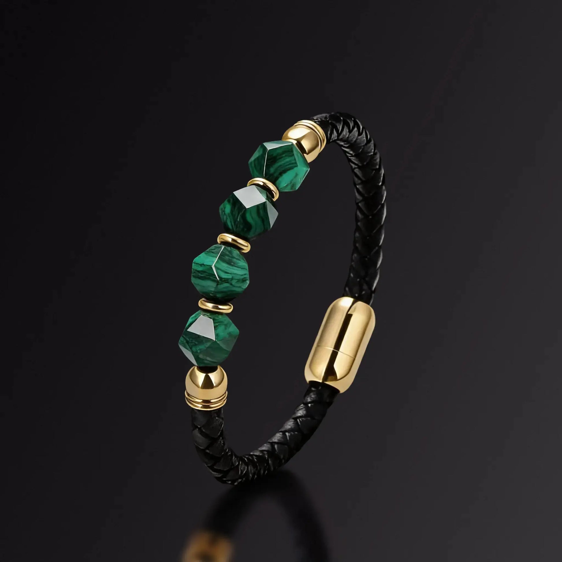 Bracelet with green beads and gold accents on a black background