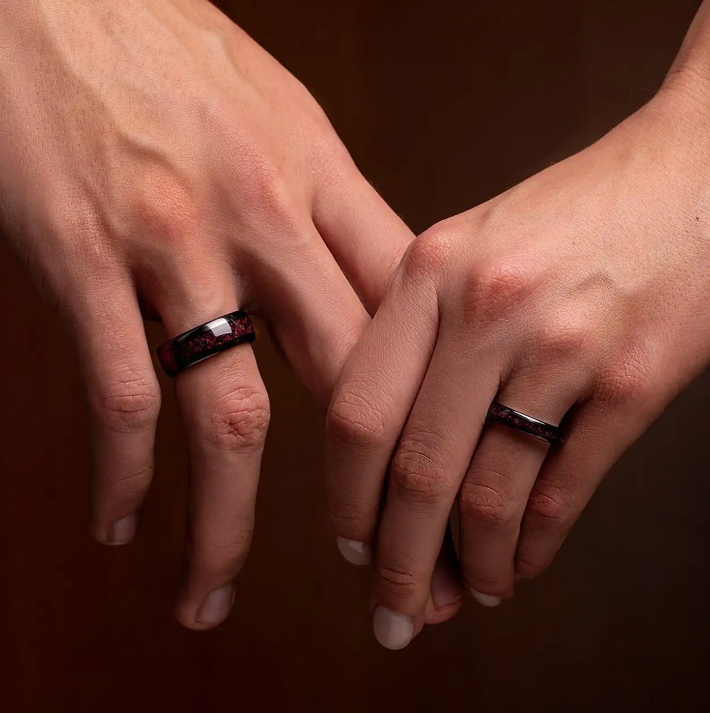 Fire Opal Matching Rings for couples, crafted from black tungsten with glowing opal inlays, shown as his and hers matching wedding rings