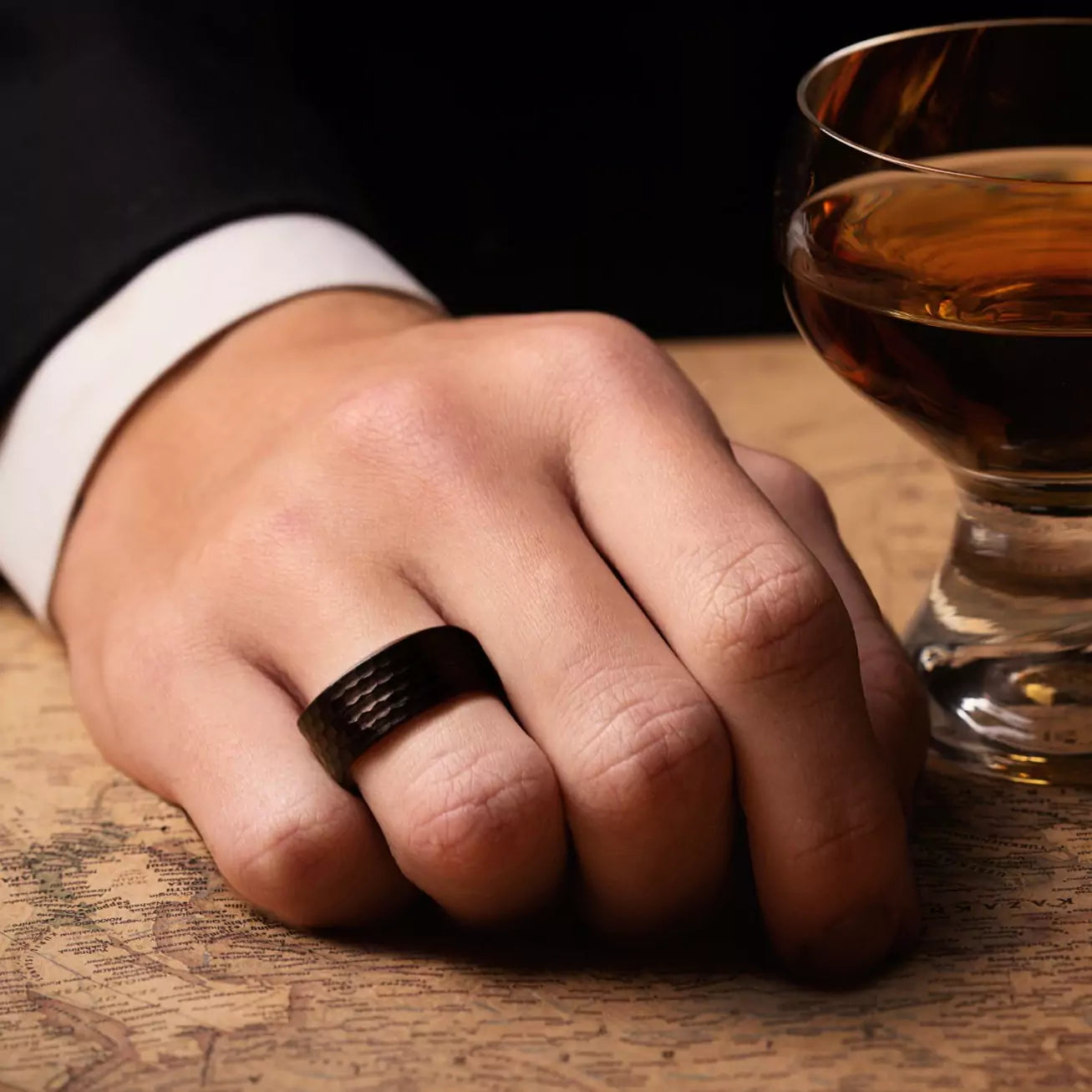 Ring made of a Rose Wood - inside layer, Hammered tungsten - outside layer. View on a man hand