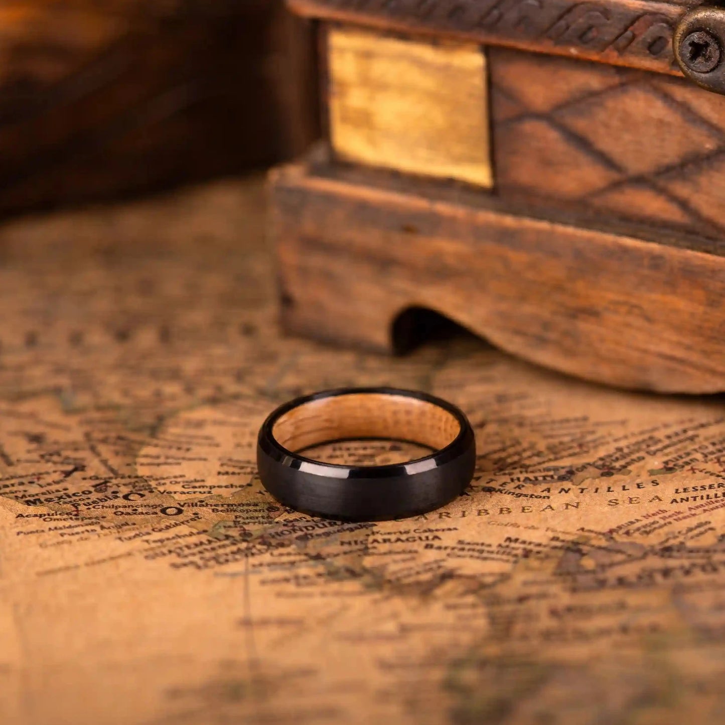 Handcrafted ring made of Oak Wood and tungsten. Version with band width 6 mm. The ring is laying on a map