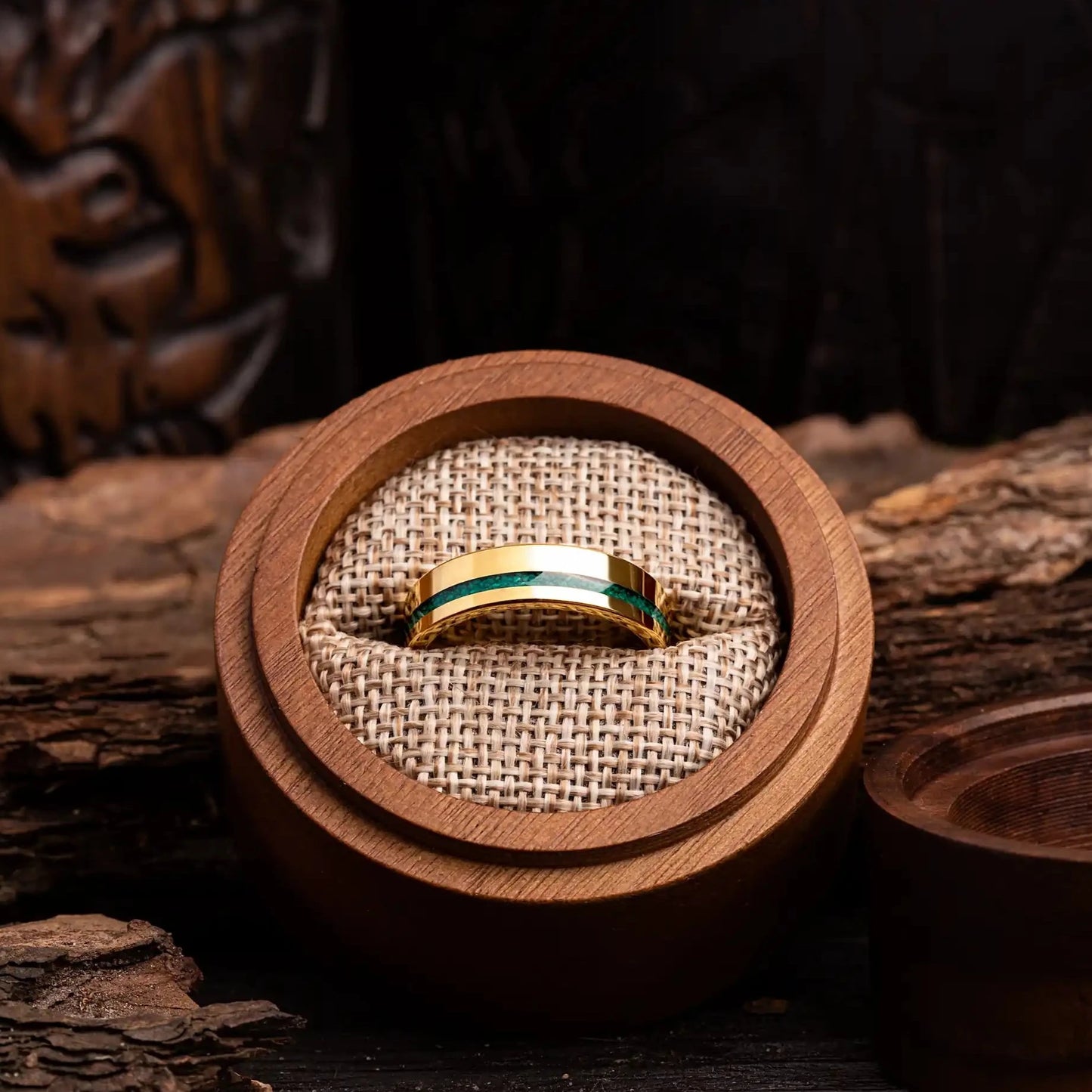 6mm gold tungsten ring with malachite. The ring is placed inside a round wooden box