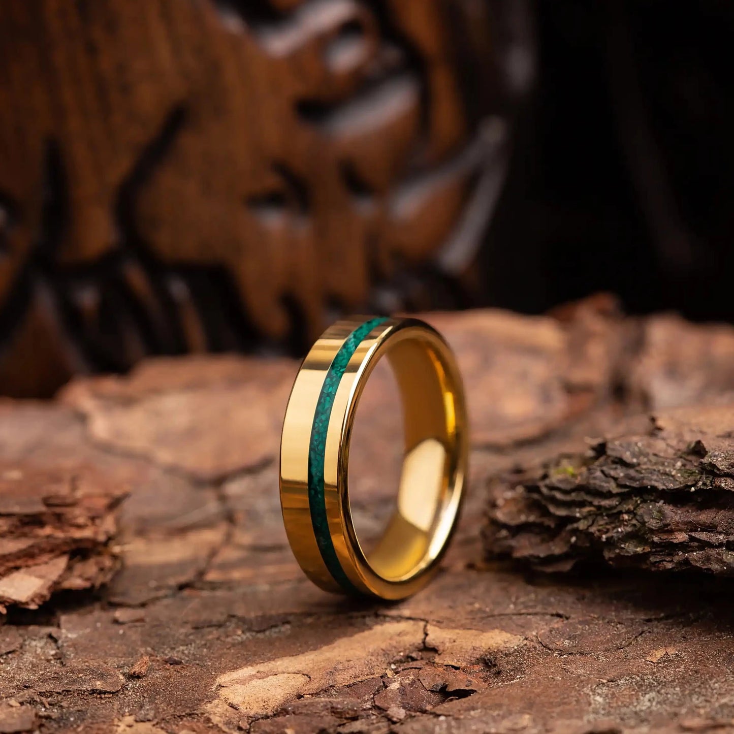 6mm gold tungsten ring with malachite. The ring is placed on a wood