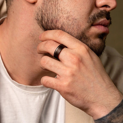 Handcrafted ring made of Oak Wood and Titanium. View on a man hand