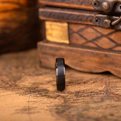 Minimalist wedding band in black tungsten with a rich oak wood inlay, designed for men seeking a unique, natural-inspired style