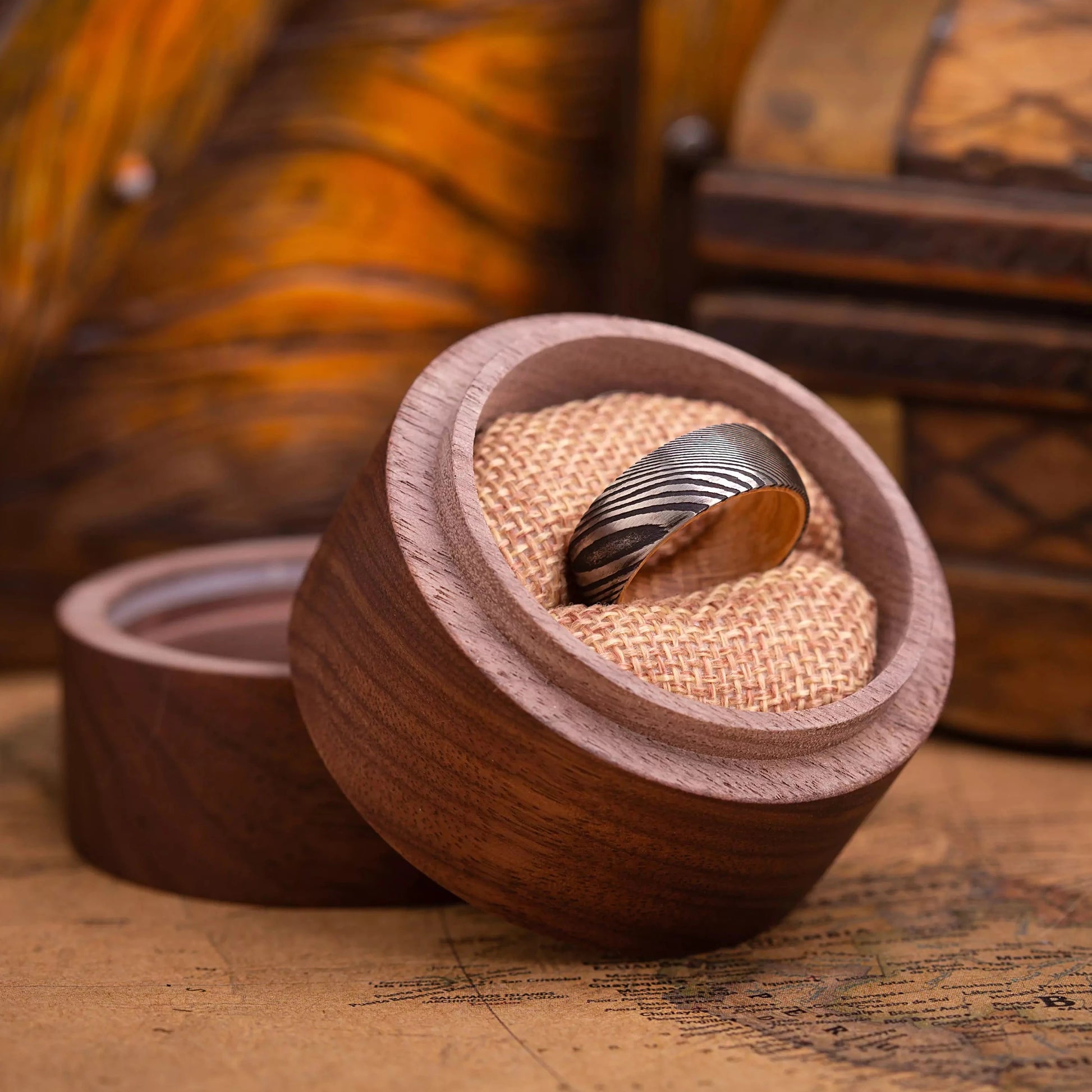 Man ring made of damascus steel and Oak Wood. View on a man hand