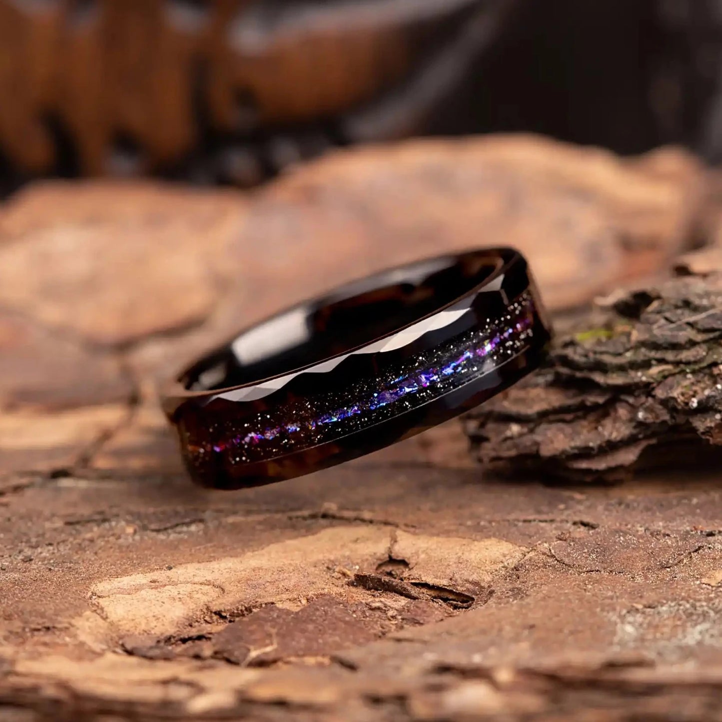 Close-up of Orion Nebula Ring, a unique hammered black tungsten carbide band with meteorite dust, 6mm width, ideal as a wedding band or promise ring.