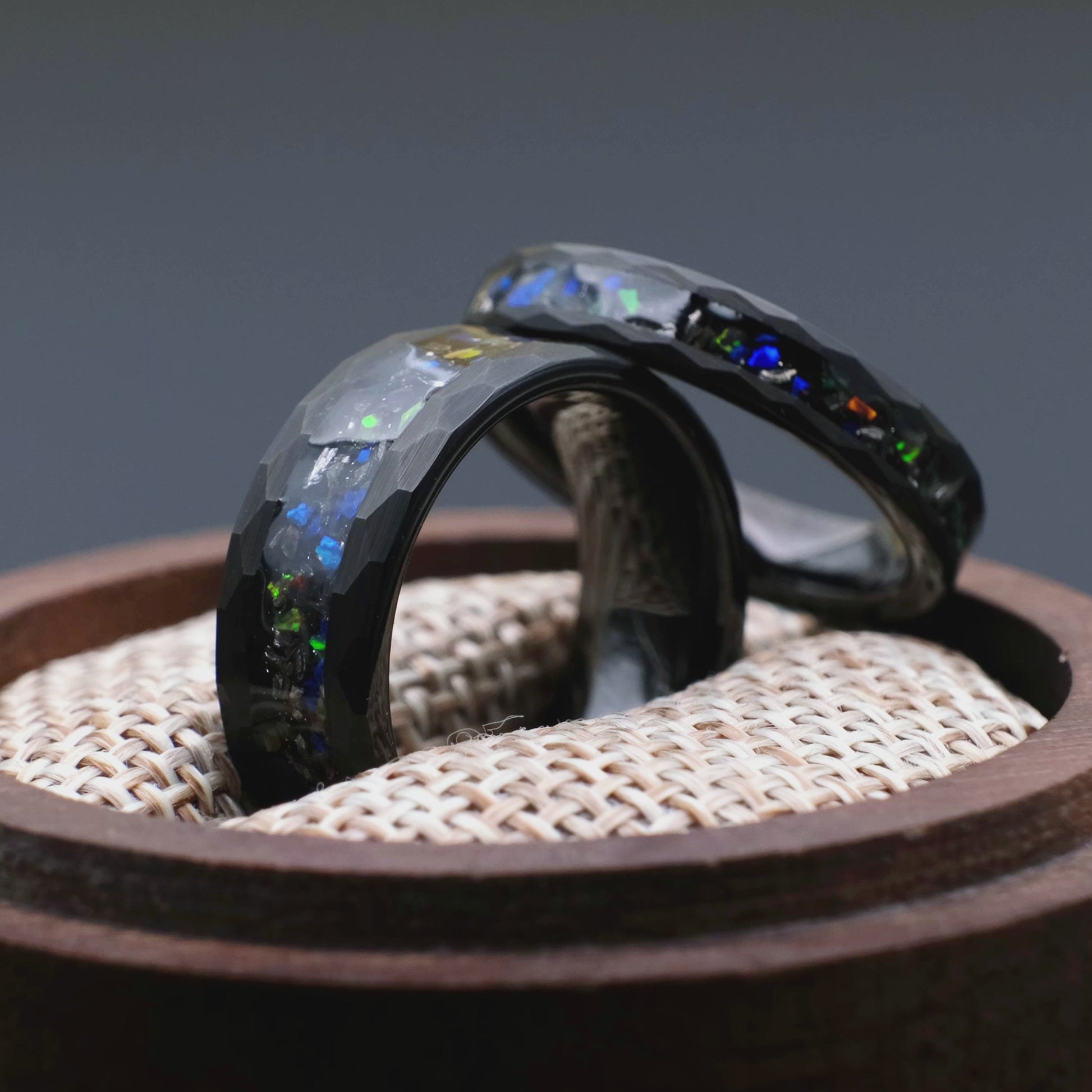 Matching wedding bands made of black hammered tungsten with galaxy opal and meteorite