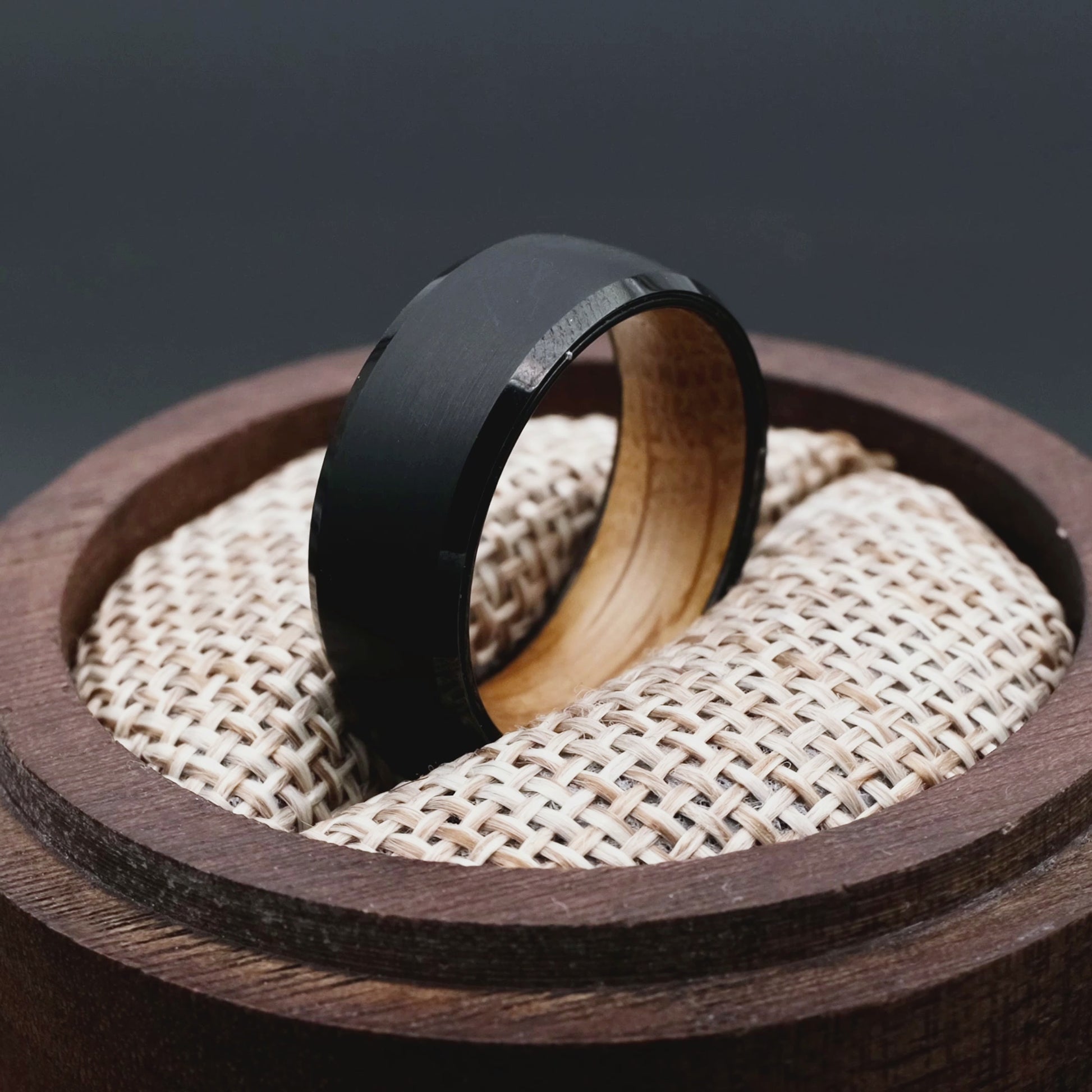 Handcrafted ring made of Oak Wood and tungsten. Version with band width 8 mm. The ring is placed inside a round wooden box.