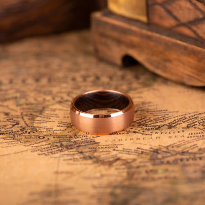 Ring made of Whiskey Barrel Oak Wood, Titanium and Tungsten. Version with band width 8 mm. The ring is laying on a map