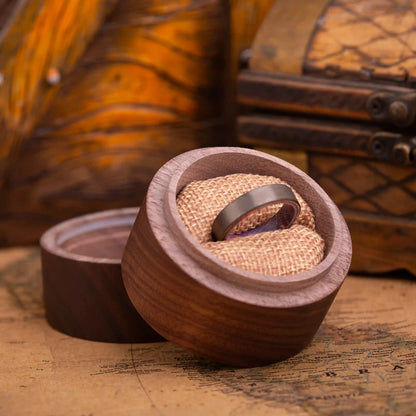 4mm Handcrafted ring made of Sakura wood and Tungsten. The ring is placed inside a round wooden box.