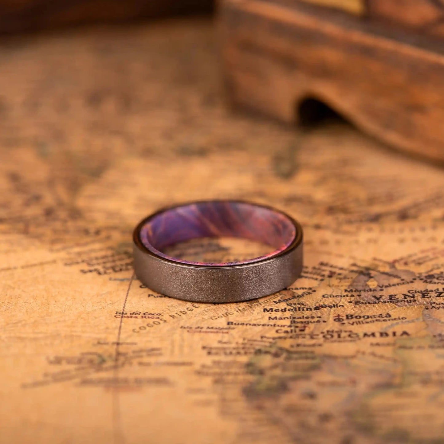 4mm Handcrafted ring made of Sakura wood and Tungsten. The ring is laying on a map