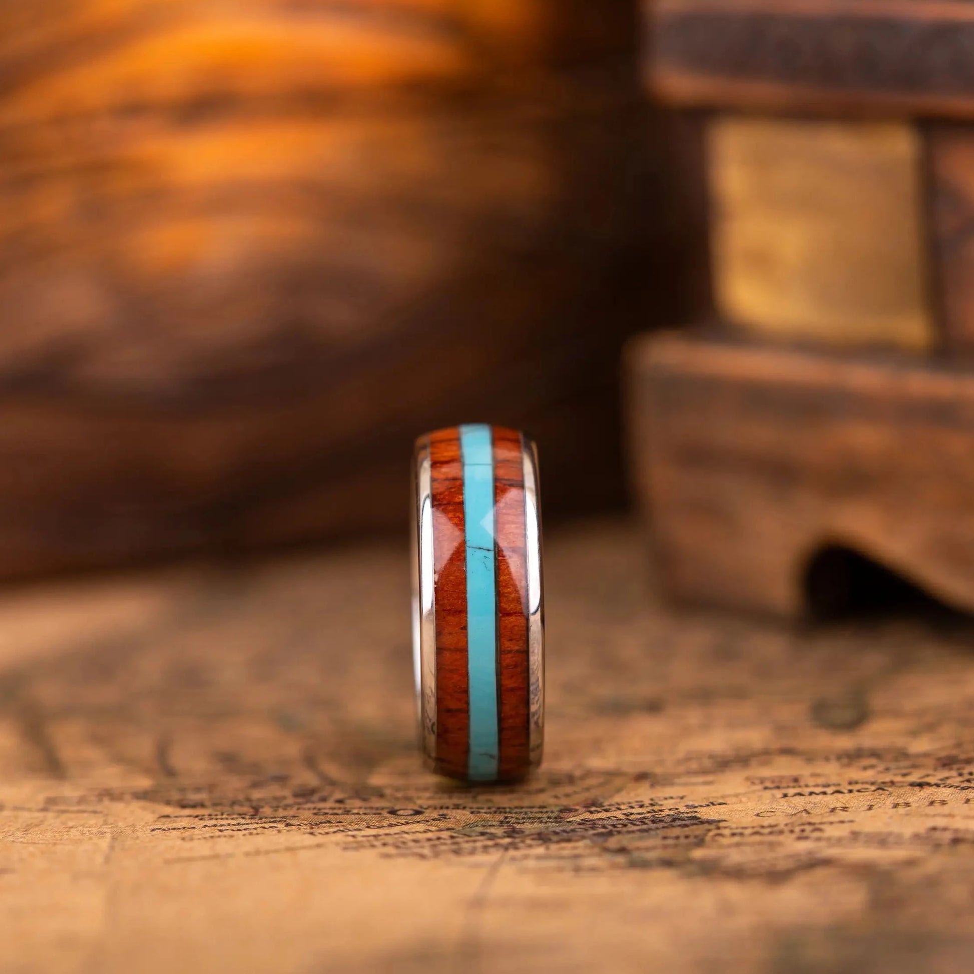 SIlver ring with turquoise and whiskey barrel oak wood in the central inlay