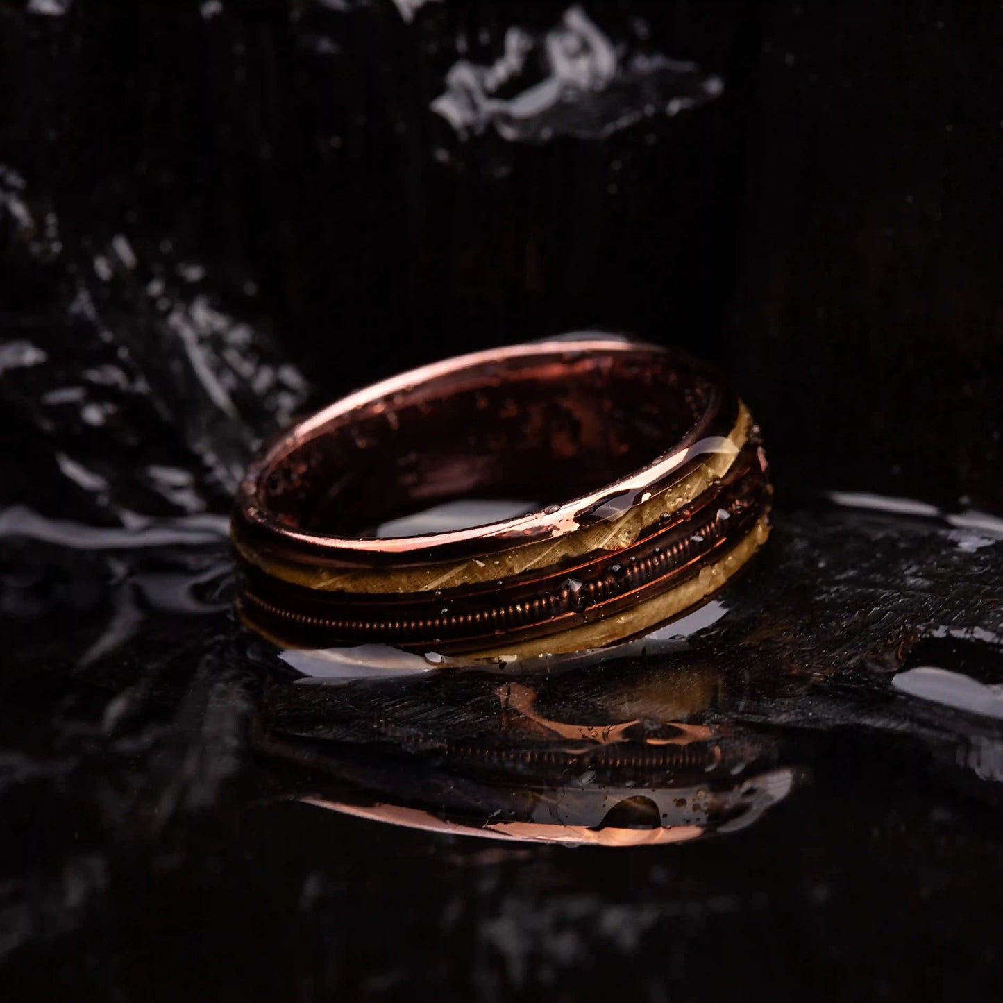 Brown brushed tungsten ring with guitar string and whiskey barrel oak wood.