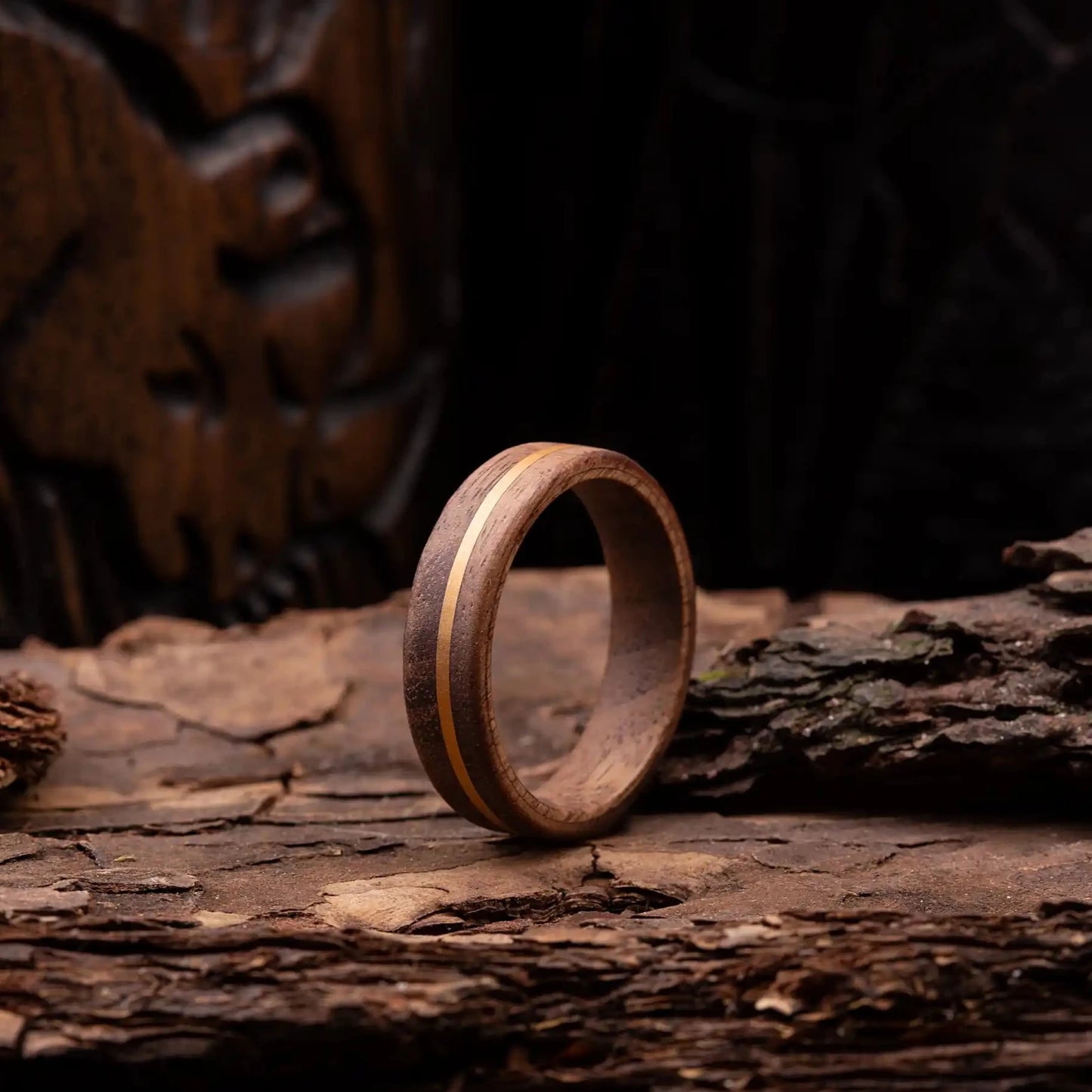 Walnut ring with copper line. The ring is placed on a wood