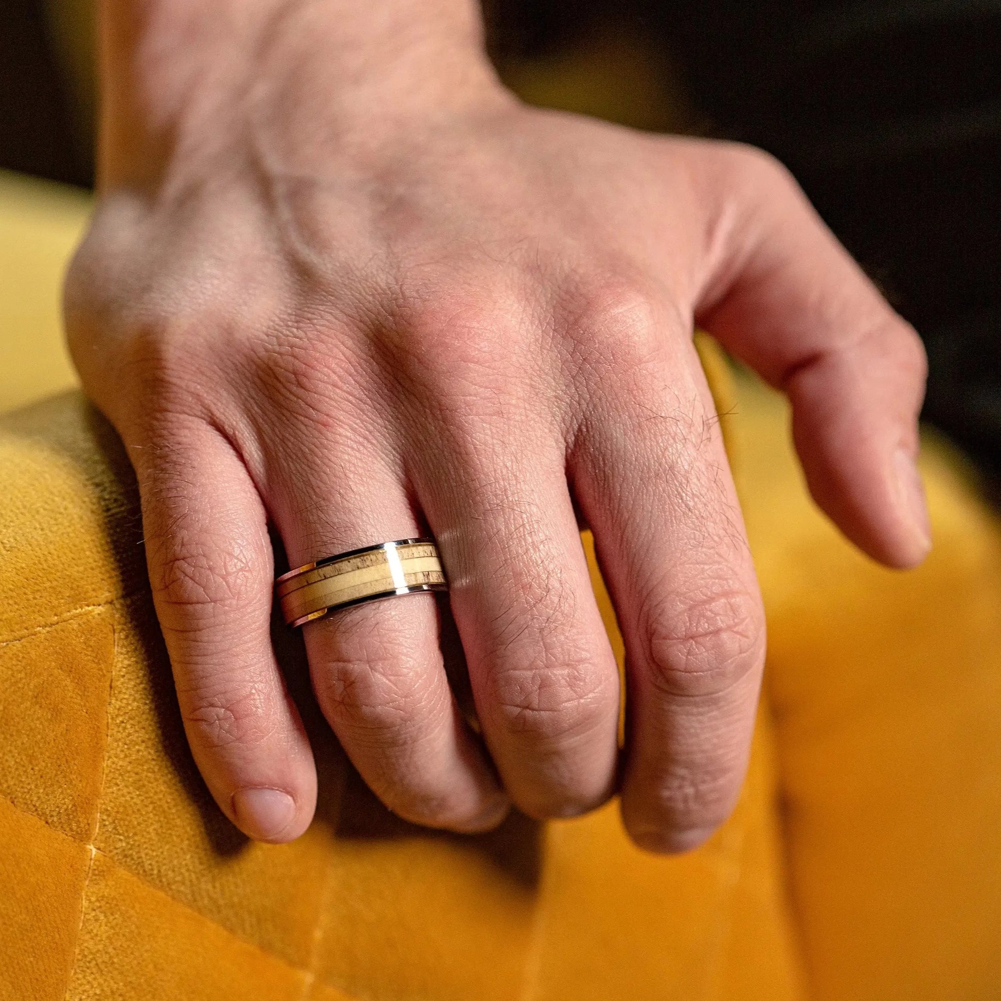 This ring made of Deer Antler and Silver Tungsten on a man hands, that hold glass of whiskey